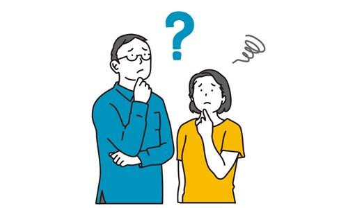 永住者資格の取消しや制度見直しについて悩む外国人夫婦のイメージ